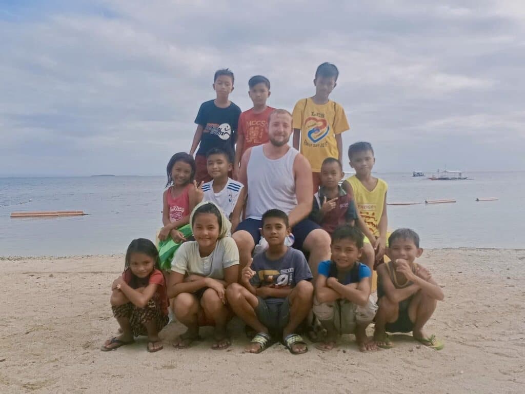 Christian on the beach, surrounded by the boys from Hay Nako.