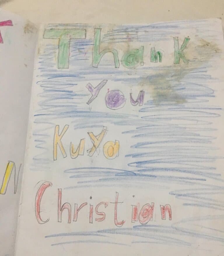 A child's drawing in coloured pencil that says: Thank you Kuya Christian.
